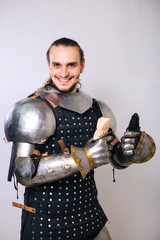 Knight with shawarma in his hands. A man in armor eats fast food. On a white background