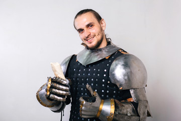 Fototapeta na wymiar Knight with shawarma in his hands. A man in armor eats fast food. On a white background