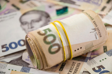 Rolled up Ukrainian money with face value of 500 hryvnia. Hryvnia background ..