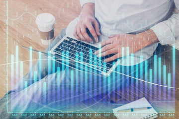 Fototapeta premium Forex graph with businessman working on computer in office on background. Concept of analysis. Double exposure.