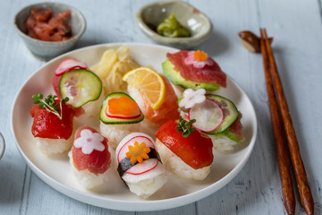 Nigiri sushi with salmon, tuna and vegetables