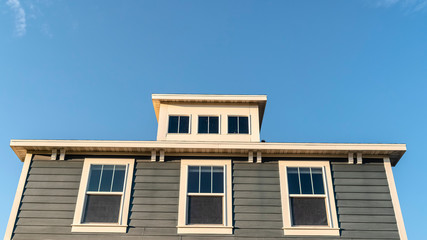 Panorama frame Grey wooden house with three upper windows