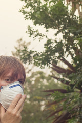 Australian bushfire: caucasian woman wearing P2 N95 protection respiratory mask to reduce amount of...