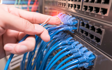 hand with damaged stranded network cable. Problem with communication