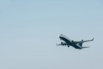 Fototapeta na wymiar Flight departure of commercial plane in blue sky