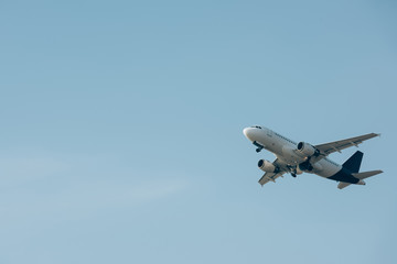 Commercial jet plane landing in blue sky