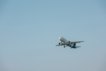 Jet plane taking off with blue sky at background