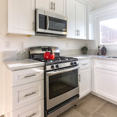 Square frame Stove with red kettle in the kitchen
