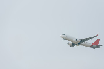 Flight departure of jet plane in cloudy sky