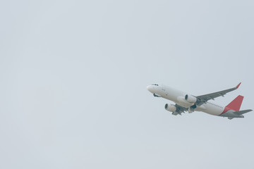 Flight departure of jet plane in cloudy sky