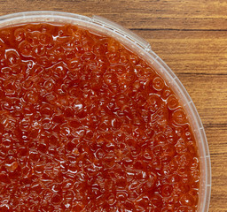 Red caviar close up macro on wood table background