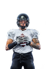 American football player. Sportsman with ball in helmet on stadium in action. Sport wallpaper. Team sports. © Mike Orlov