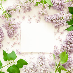 Creative layout of lilac flowers with space for text on white paper. Mockup. View from above. - Image