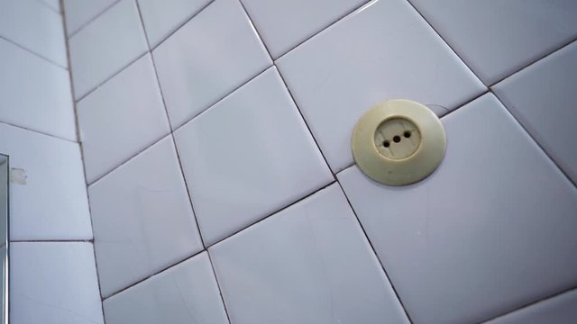 An old socket on the wall. Short circuit. Old power grid. Voltage drop in the room. Danger. Power source.