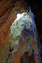 Sun beam through the hole of cave