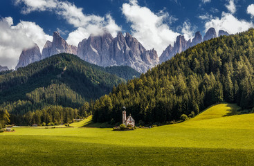 Fototapeta na wymiar Awesome alpine Landscape. Famous best alpine place of the world, Santa Maddalena (St Magdalena) village with magical Dolomites mountains in background, Val di Funes valley, Trentino Alto Adige. Italy