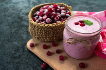 Frozen cranberry yogurt on a black background. The concept of healthy desserts. Close-up.