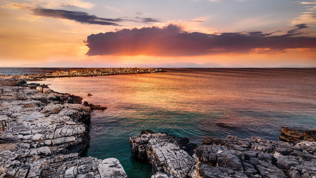 Fantastic colorful seascape during sunset. Nature in twilight period which including of sunrise over the sea and the nice rocks beach.