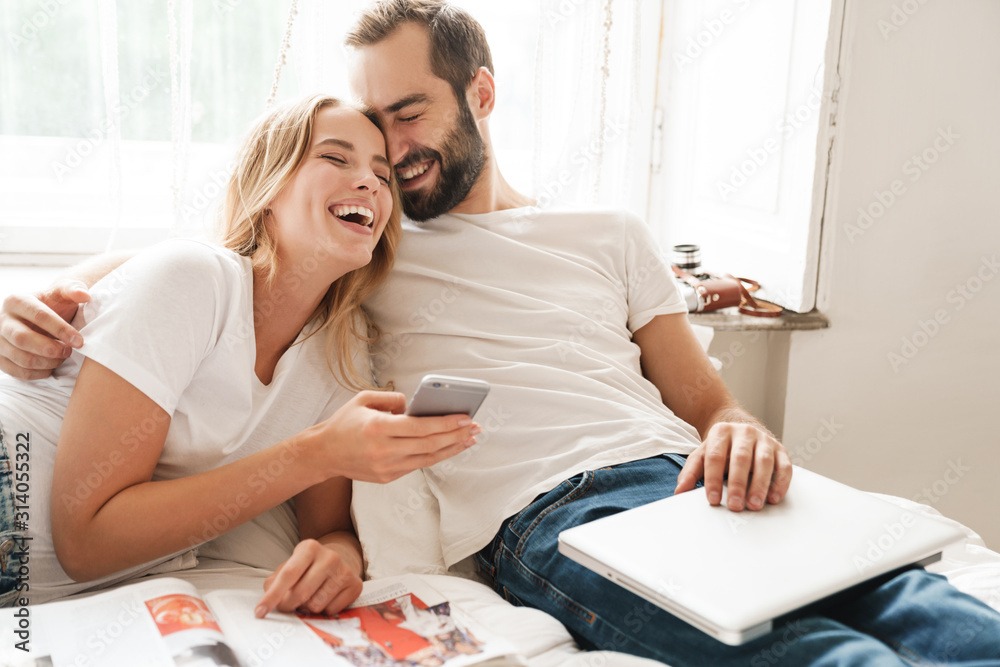 Poster beautiful young couple relaxing on bed