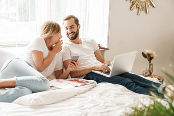 Beautiful young couple relaxing on bed