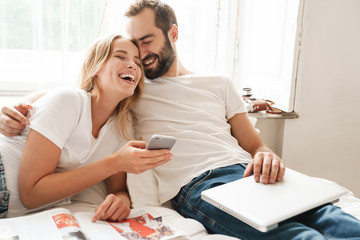 Beautiful young couple relaxing on bed