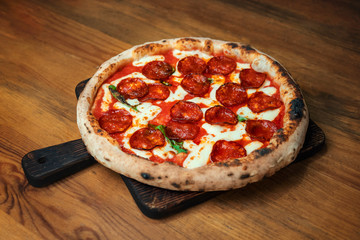 Freshly baked pizza pepperoni on a wooden table