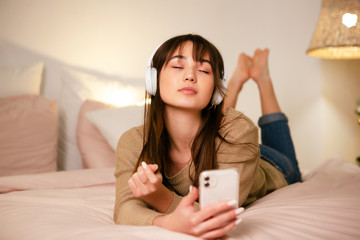 The girl with bluetooth headphones and a phone