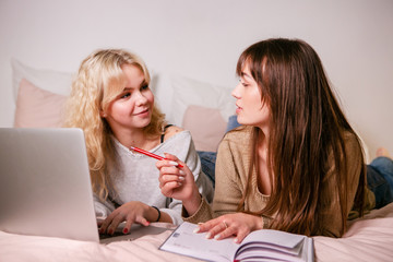 Smiling girls student study at home with laptop