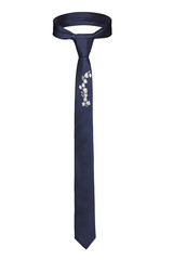 Subject shot of a classic tie made of blue silky fabric with embroidered white flowers. The necktie is isolated on the white background.