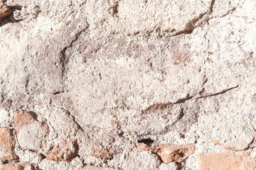 Element of old stone and concrete wall in sunny day. Perfect grunge textured background. Copy space. Rough wallpaper.