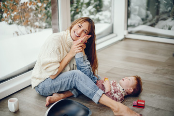 Beautiful mother with son. Family at home. People in a Christmas decorations.