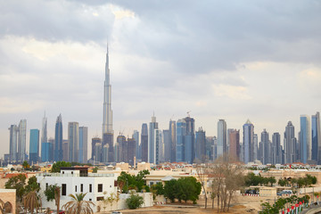 Obraz premium Burj Khalifa skyscraper, Dubai skyline and residential area in a cloudy day