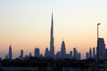 Fototapeta na wymiar Dubai skyline with Burj Khalifa skyscraper at sunset, clear sky in United Arab Emirates