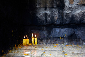 Melting church wax candles on the stone floor.