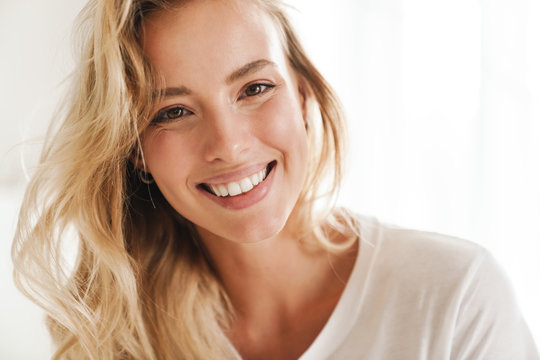 Smiling young beautiful blonde woman wearing t-shirt