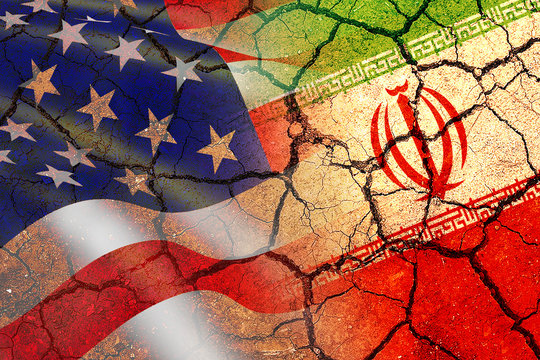 Concept Of Conflict Between USA And Iran War - US America And Iran Flags On Split Up Dried Cracked Earth Soil Ground