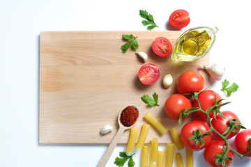 Clean healthy eating habits concept. Uncooked pasta, greens & vegetables mix and other vegan macaroni ingredients, white background. Vegetarian diet food. Flat lay, copy space