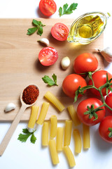 Clean healthy eating habits concept. Uncooked pasta, greens & vegetables mix and other vegan macaroni ingredients, white background. Vegetarian diet food. Flat lay, copy space