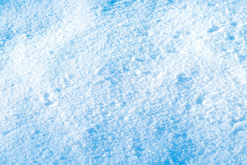 Fototapeta na wymiar Background of sunny snow texture in blue tone.
