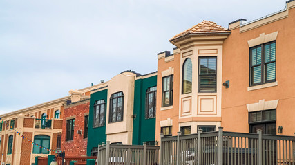 Fototapeta premium Pano Exterior of buildings in Park City Utah with balconies against cloudy sky