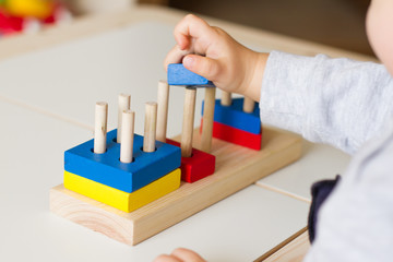 Toy made of wood for the study of shapes and colors. Useful game for a child on a white table. Montessori Education. Materials for the school. Materials on geometry. the concept of teaching children.