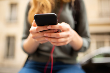 Close up young woman hands holding mobile phone
