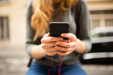 front portrait of young woman hands holding mobile phone
