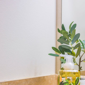 Square Countertop With Towels Soap And Plant On Tray Against White Wall And Mirror