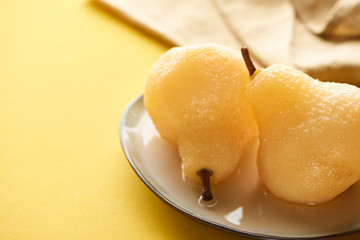 selective focus of delicious pear in wine on plate near napkin