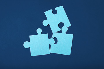 Puzzle pieces on classic blue background top view