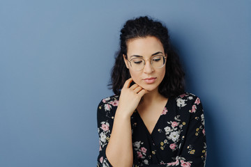 Thoughtful sad young woman with downcast eyes