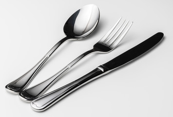 Spoon, fork and knife on a white background
