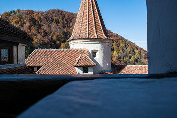 the top of the Bran castle seen from an old window. beautiful view on the mountain.