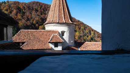 the top of the Bran castle seen from an old window. beautiful view on the mountain.